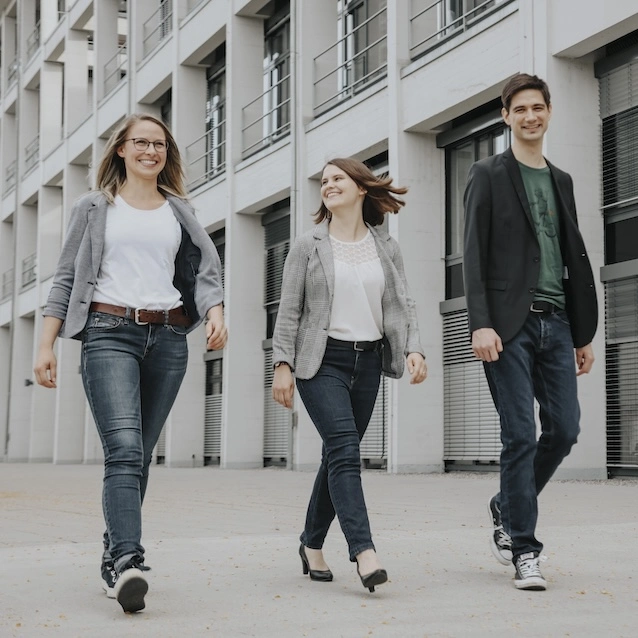 3-member Burgdörfer team dynamically walking towards the camera.